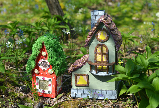 Cute fairy doll house or village outside in the garden. Lovely miniature for greeting cards, wedding or birthday concept, real estate, downsizing, home ownership. Vintage background