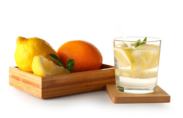 Glass of infused water and wooden box with different citrus fruits on white background