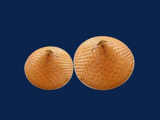 The dark blue background in the picture is a beautiful, intricately woven basket made from bamboo painted in beautiful brown colors. There is a head cover inside that is made into a circle. 