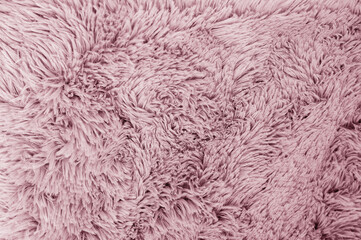 Soft and fluffy rose-colored fabric, perfect for creating a warm, inviting background texture.