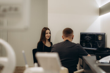 Dentist Consults Patient With X-Ray Results in a Modern Dental Office