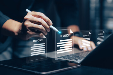 Digital Invoice Management: A hand uses a stylus to interact with glowing virtual invoices on a tablet/laptop screen, symbolizing efficient paperless transactions, online billing, and modern business.