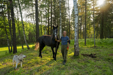 rustic man with  horse in rural village near  forest.  horse farm is surrounded by nature, hay is stacked nearby,  peaceful and traditional.  man is caring for  horse