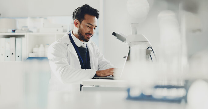 Man, laptop and scientist in lab for research report, medical review or microscope with online analysis. Science, male doctor and computer for typing evaluation, forensic study and innovation tech