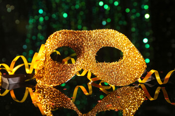 Golden carnival mask on dark background