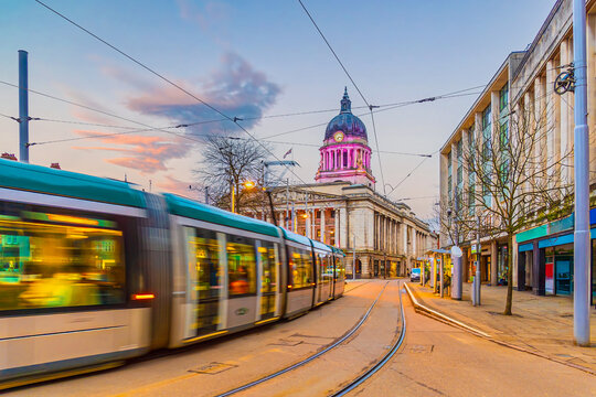 Tram in downtown Nottingham city, cityscape of England at twilight