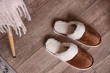 Male warm slippers on laminate floor