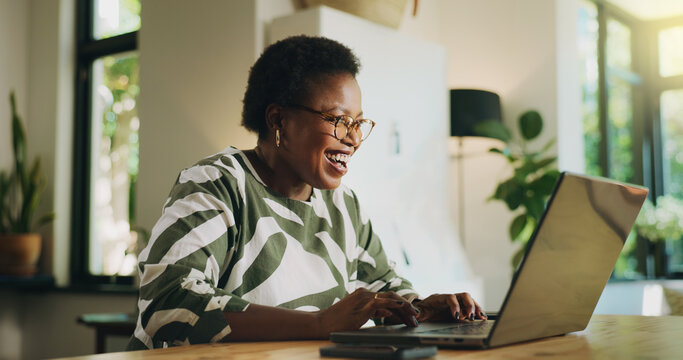 Budgeting, black woman and happy with laptop in home for loan approval, debt free and rebate. Excited, person and account review in apartment for financial planning, asset management and tax return