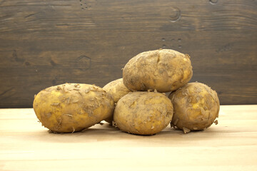 Freshly Harvested Potatoes Arranged Neatly on a Wooden Surface Indoors