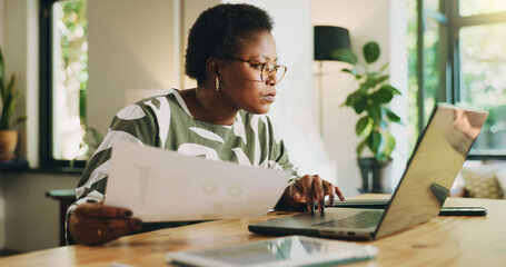 Black woman, document and typing on laptop at house for accounting, finance report and remote work....