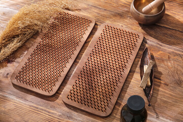 Sadhu board with Tibetan singing bowl, Palo Santo and pampas grass on wooden background