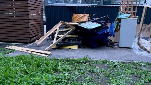 Unsorted bulky garbage and household waste illegally dumped outdoors. Environmental pollution, urban littering and ecological problem in city or countryside. Concept of trash and waste management cris