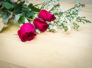 Bouquet of red roses on wooden floor