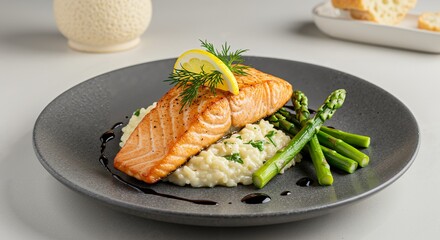 Delicious Grilled Salmon with Asparagus and Creamy Risotto on a Modern Plate
