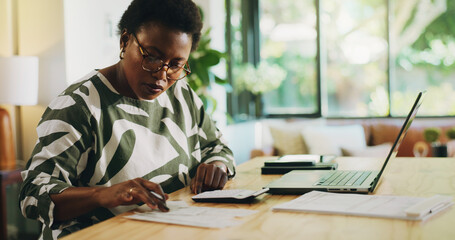 Finance, budgeting and black woman with invoice in home for financial planning, savings or auditing. Wealth, person or laptop with receipt documents for tax return, account review or asset management