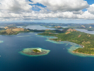 Tourist boats in CYC Beach. Uson Island with turquoise sea water and corals. Coron, Palawan....