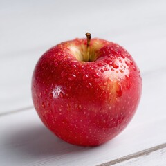 Single vibrant red apple with water droplets sits on a white wooden surface showcasing its natural texture and color