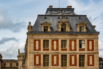 Fototapeta premium Exterior Facade of Large Building with Slate Roof at Versailles Gardens, Paris.