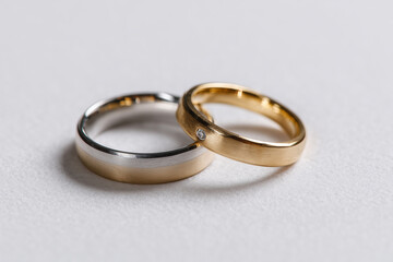 elegant couple rings in minimalist silver and gold colors on white background