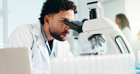 Man, scientist and microscope for medical study, research or forensic science at laboratory. Male...