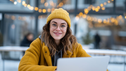 Young professional working remotely on laptop during winter season