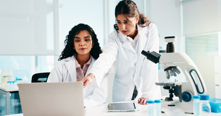 Woman, scientist and team with laptop, review and collaboration for medical research at laboratory. People, computer and feedback for pharmaceutical project with point, innovation and perspective
