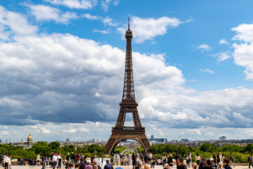 Eiffel Tower View with People and Cityscape Under Cloudy Sky