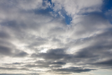 The sky is cloudy and the sun is shining through the clouds