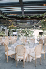 lovely Table setting for magnificent composition from flowers at a wedding , Centerpiece white and orange color palette flower bouquet arrangement