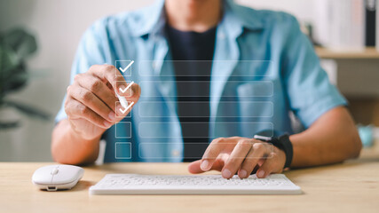 Person using digital pen and keyboard to check off tasks in virtual checklist interface. Concept of...