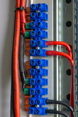 Power cables connection using screw connectors in electrical power distribution cabinet.