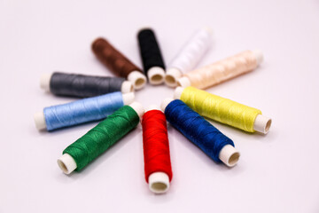 spools of thread on a white background, closeup of photo