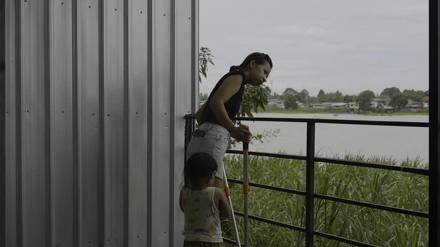 Toddler And His Mother Are Helping To Cut Weeds, Video footage for documentary film and cinematic in lifestyle scene.