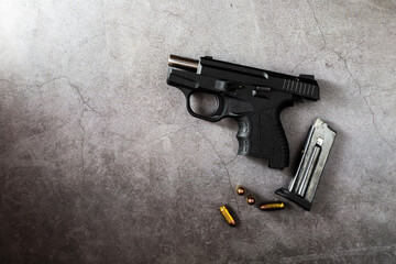 Handgun on Gray Concrete Surface with Bullets and Magazine