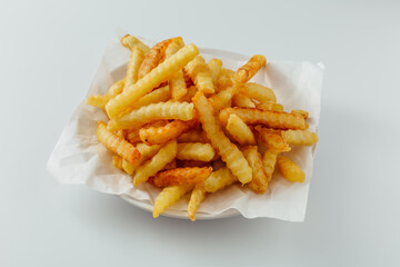 Crispy Crinkle Cut French Fries on a White Plate with Paper Liner