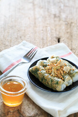 Fresh Herbal Rice Rolls with Peanut Sauce and Garnish on Table