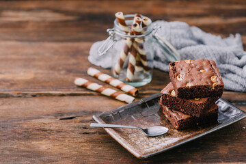 Delicious Brownies on a Plate with Chocolate Straws and Texture