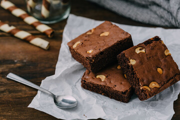 Delicious Chocolate Brownies with Nuts on Crumpled Paper Surface