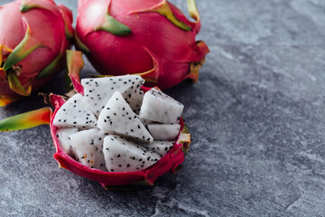 Fresh Dragon Fruit with Slices on Gray Stone Background