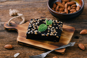 Rich Chocolate Dessert with Nuts on Rustic Wooden Background