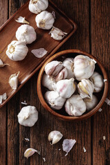 Fresh Garlic Bulbs and Cloves on Wooden Surface for Culinary Use