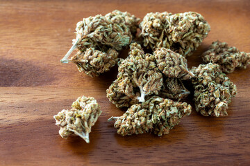 Close-up of Natural Cannabis Buds on Wooden Surface