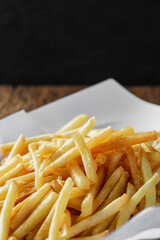Crispy French Fries on a White Plate with Dark Background