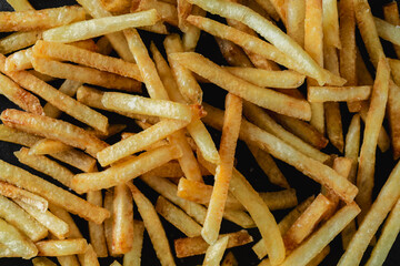 Crispy French Fries Laid Out on a Dark Surface for Food Photography