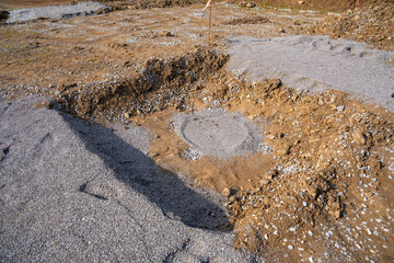 Plate load test results visible on soil surface after static pressure application. Ground investigation for foundation suitability and load-bearing capacity