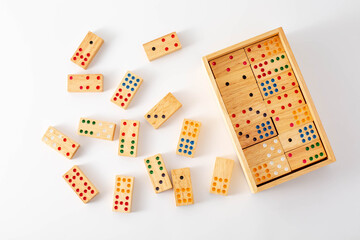Wooden Dominoes in a Box with Colorful Dots on a White Surface
