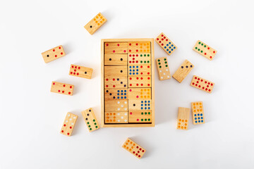 Colorful Wooden Dominoes in Open Box on White Background