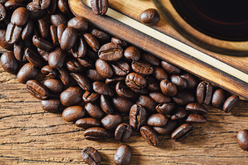 Freshly Roasted Coffee Beans Spilling on Rustic Wooden Surface