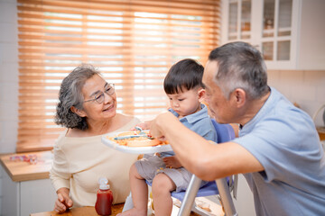 Family enjoys mealtime together in a cozy kitchen with a toddler exploring food on a high chair