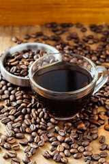 Fresh Brewed Coffee with Roasted Beans on Rustic Wooden Table